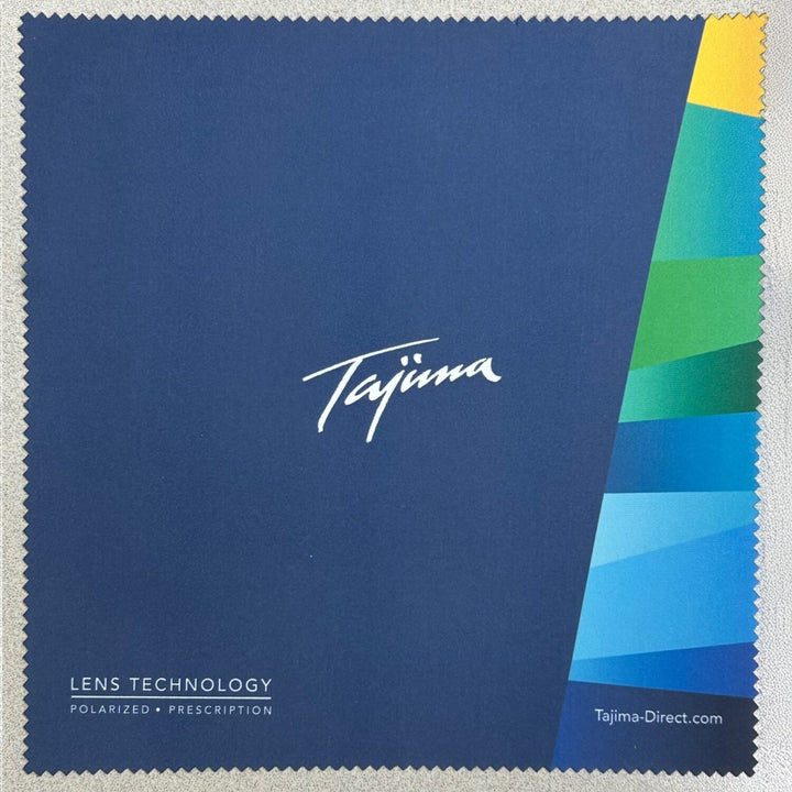 Flat lay of Tajima branded microfiber lens cleaning cloth showing full design with color stripe detail