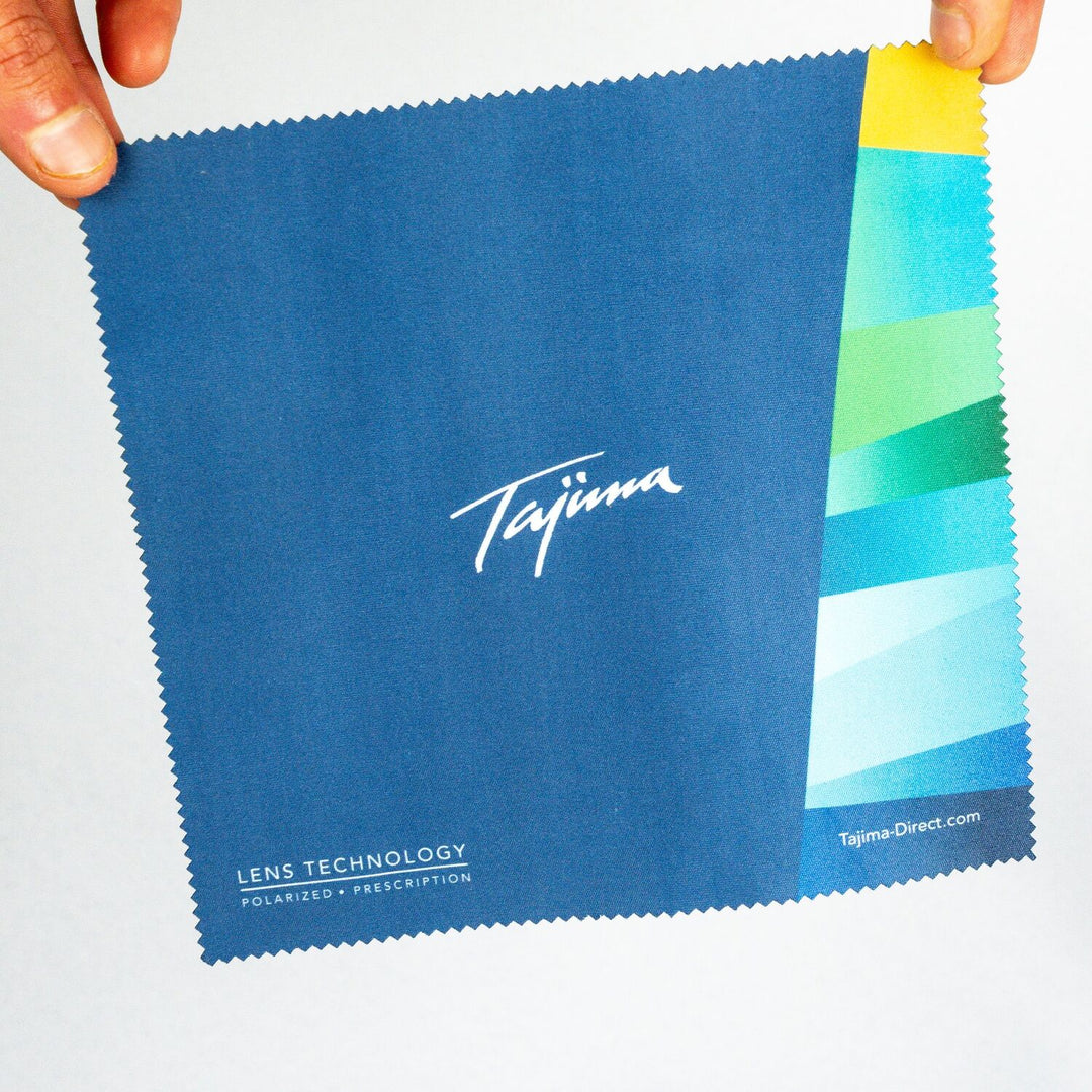 Tajima microfiber cloth held up displaying front branding and dimensions