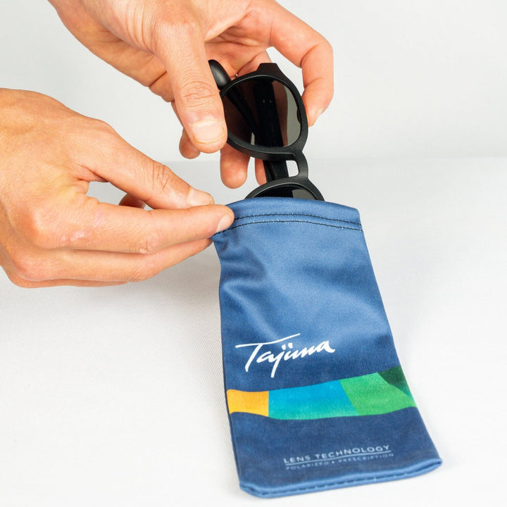 Sliding sunglasses into Tajima microfiber drawstring storage pouch