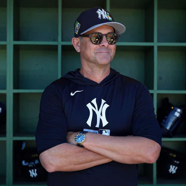 Aaron Boone standing in the dugout wearing basn5 Highway 1 sunglasses with gold mirror Tajima polarized lenses
