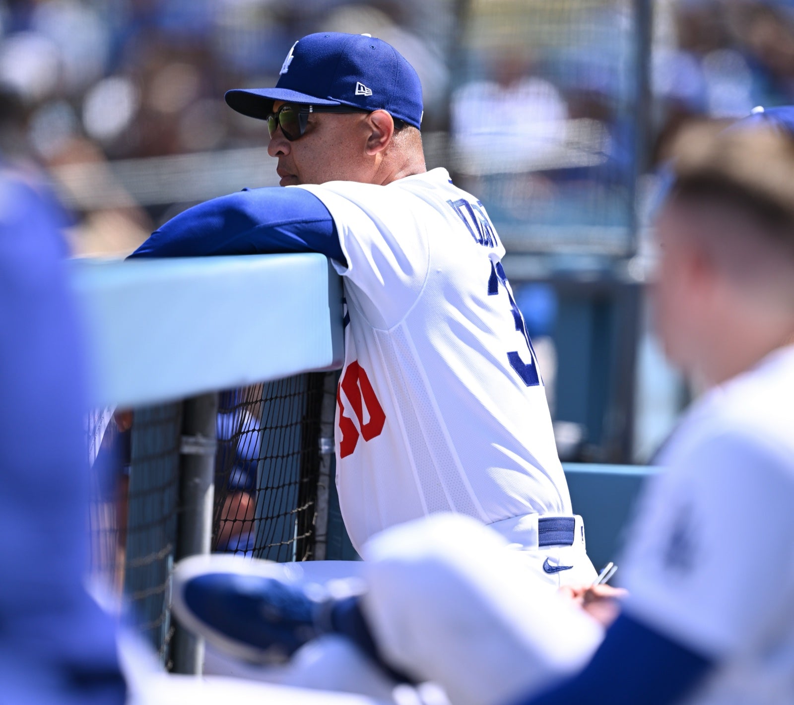 Dave Roberts wearing basn5 Davenport sunglasses leaning on the dugout rail at Dodger Stadium